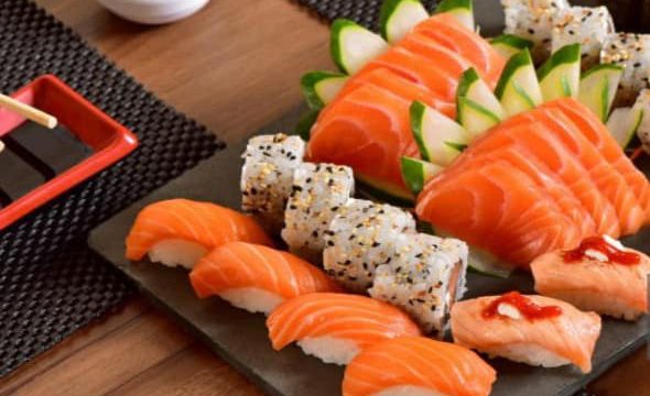 Japanese food mix on rustic board in a restaurant table