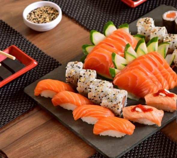 Japanese food mix on rustic board in a restaurant table